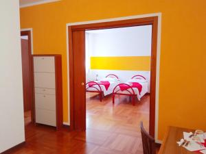 a room with a dining room with orange walls at Casa Accademia in Venice