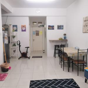 a room with a table and some chairs and a room with a table at UNIE HOMESTAY in Wakaf Che Yeh
