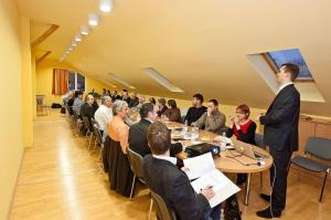 a group of people sitting at tables in a room at Stan és Panzió in Balatonalmádi