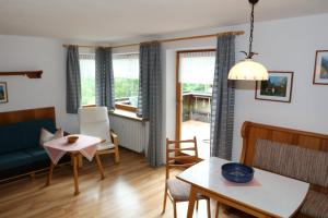 a living room with a couch and a table at Gästehaus Gmundtal in Bischofswiesen