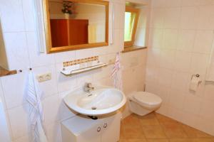 a bathroom with a sink and a toilet at Gästehaus Gmundtal in Bischofswiesen +16 photos
