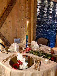 a table with a white table cloth and a candle on it at Hotel Mirabello - Slow Hotel Benessere in Fiera di Primiero