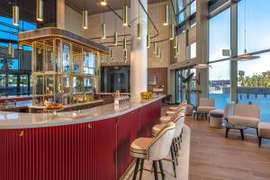 a lobby with a bar with chairs and tables at Melia Valencia in Valencia