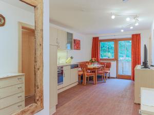 a kitchen and a dining room with a table at Koglbauer - Apartment Nr 3 in Söll