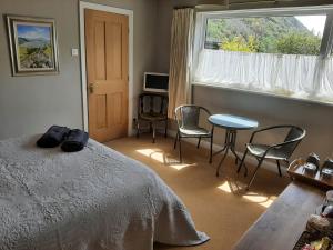 
a bedroom with a bed and a desk at The Coach House in Beddgelert
