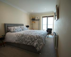 a bedroom with a bed and a window at Seventeen Carrig Na Rone in Portrush