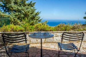 two chairs and a table with glasses on it at Mathia Apartments in Mathía