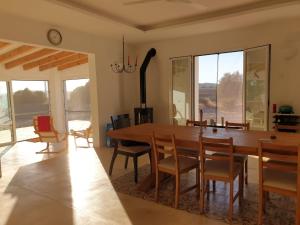 a dining room with a large wooden table and chairs at Milagro de Algar in Vejer de la Frontera