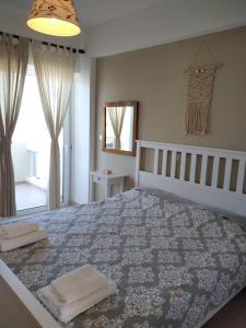 sypialnia z dużym łóżkiem z dwoma ręcznikami w obiekcie Almirikia Apartments w mieście Mourteri