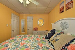 a bedroom with a large bed and a mirror at Bright Dog-Friendly Escape with Direct Beach Access! in Ocean City