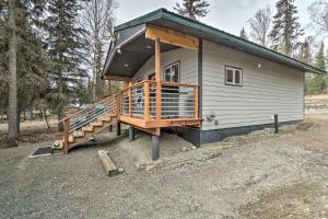 a tiny house with a porch and a staircase at Cozy Downtown Soldotna Cabin Dogs Welcome! in Soldotna