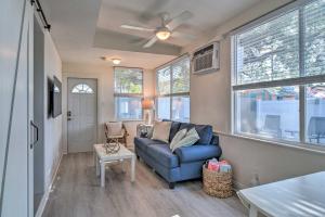 a living room with a blue couch and windows at Florida Unit Steps from Indian Rocks Beach Access! in Clearwater Beach