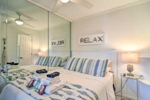 a bedroom with two beds and a large mirror at Florida Unit Steps from Indian Rocks Beach Access! in Clearwater Beach
