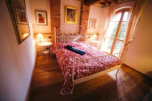 a bedroom with a bed with a book on it at Borgo 7 TigliAppartamento a Montepulciano n1 in Montepulciano