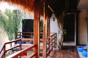 um alpendre de uma casa com telhado de palha em Hotel Uolis Nah em Tulum