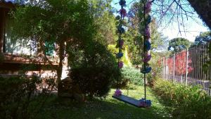 a yard with a tree with balls hanging from it at Chalé Martinho in Gramado +76 photos