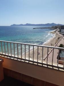 a balcony with a view of a beach and the ocean at Sky Beach Can Picafort in Can Picafort