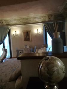 a bedroom with a bed and a globe on a table at Loft ‘900 in Ravenna