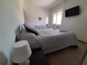 A bed or beds in a room at Ca l'Aren Cardona