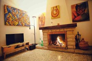 a living room with a fireplace and a flat screen tv at Casa rural “Ca Robert” in Callosa de Ensarriá