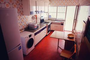 a kitchen with white appliances and a table in it at Casa rural “Ca Robert” in Callosa de Ensarriá