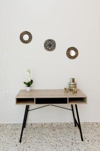 a desk against a white wall with two mirrors at Alion House in Rhodes Town