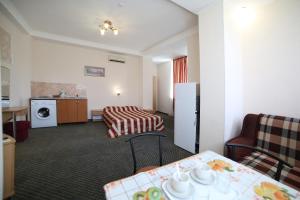 a hotel room with a table and a living room at Flamingo Hotel in Alushta