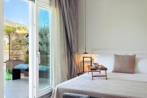 a hotel room with a bed and a balcony at Domìa Boutique Hotel e Cucina in Mondello