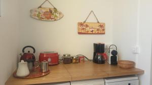 a kitchen counter with appliances on a wooden counter top at Bastia Appartement 3 chambres vue mer in Bastia