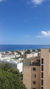 a view of a city with a building and the ocean at Bastia Appartement 3 chambres vue mer in Bastia