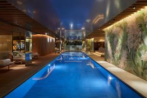 a large swimming pool in a building at 45 Park Lane - Dorchester Collection in London