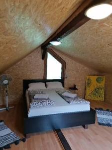 a bedroom with a bed in a room with a window at La Cabana in Băile Herculane +43 photos