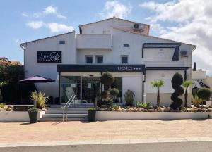 a store front of a building with a hotel at Hôtel L'Escale Coté Port in LʼÎle-Rousse
