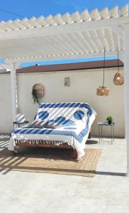 a bedroom with a bed with a blue and white blanket at Arenas house in Torrevieja