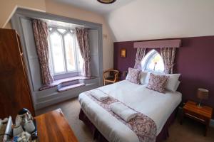 a bedroom with a large bed and a window at The Lemon Tree in Wrexham