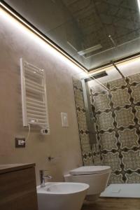 a bathroom with a toilet and a sink and a mirror at LA DIMORA DEL PRINCIPE-Loft in Trani