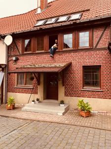 a man sitting on the roof of a house at Lissy‘s alte Schmiede in Kleinwerther