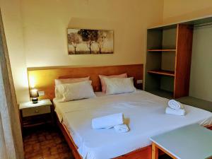 a bedroom with two beds with towels on them at Pension Irene in Sougia