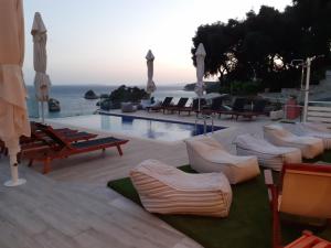 a view of a pool with chairs and a swimming pool at Agnanti in Parga