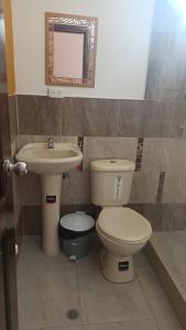 a bathroom with a toilet and a sink at Hostería La Chorrera in Quito