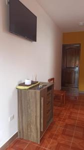 a living room with a flat screen tv on a wall at Hostería La Chorrera in Quito