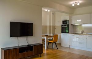 a living room with a flat screen tv on the wall at Panorama Apartment in City-Centre in Sarajevo