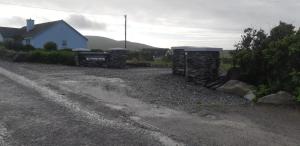 a gravel driveway with a house in the background at Atlantic Sunset in Portmagee
