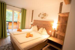 Postel nebo postele na pokoji v ubytování Gasthof Klug zum Ehrensepp