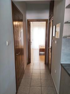 a hallway with a door leading to a room at Sea View Apartments Nikos in Nea Peramos