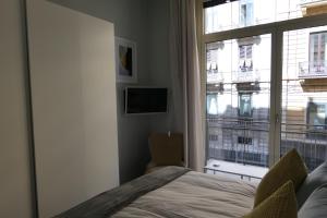 a bedroom with a bed and a large window at Casa Consoli in Catania