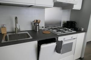 a kitchen with a sink and a stove at Casa Consoli in Catania