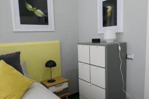 a bedroom with a bed and a dresser with a lamp at Casa Consoli in Catania