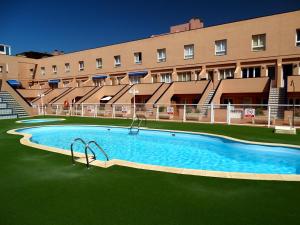 a large swimming pool in front of a building at Casa Paula in Corralejo