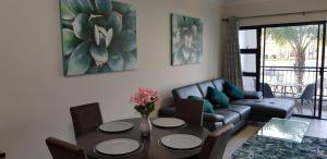 a living room with a table and a couch at Blyde Lagoon View Apartment in Pretoria